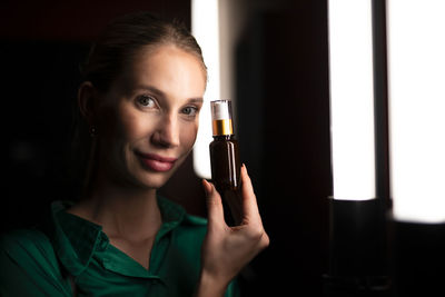 Close-up of woman holding bottle