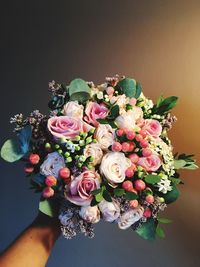 Close-up of hand holding rose bouquet