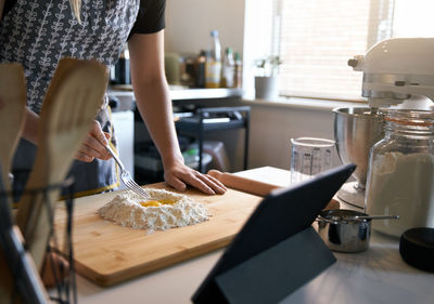 Midsection of woman having baking at home