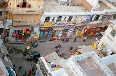 High angle view of people on street amidst buildings