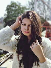 Close-up portrait of young woman standing outdoors