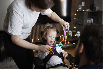 Mother taking care of disabled child at home