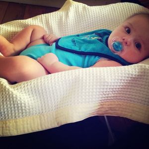 Portrait of cute baby girl lying on bed