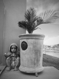 Portrait of cute girl sitting on palm tree