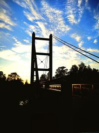 Low angle view of silhouette bridge against sky