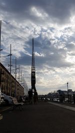 View of cityscape against cloudy sky