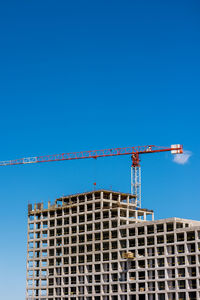 Construction of a residential building, against the blue sky.  home construction