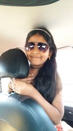 Portrait of smiling young woman wearing sunglasses