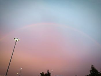 Low angle view of rainbow against sky at sunset