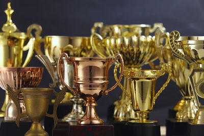 Close-up of trophies against black background