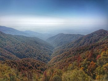 Scenic view of mountain range against blue sky