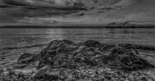 Scenic view of sea against cloudy sky