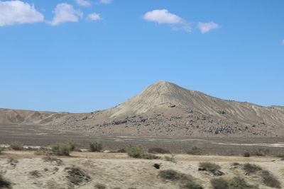 Scenic view of arid landscape against sky