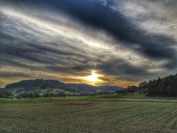 Scenic view of field against sky during sunset