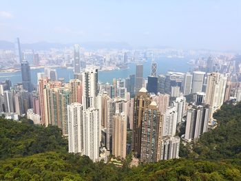 Aerial view of buildings in city against sky