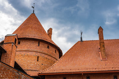 View of the red tiled roof and red brick masonry of the towers of trakai castle, trakai, lithuania