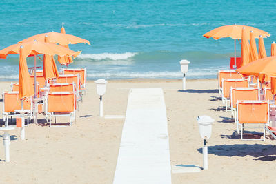 Lounge chairs and parasols on beach