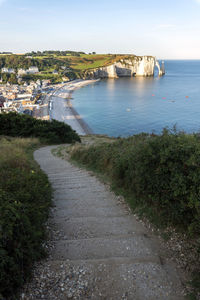 Scenic view of sea by buildings against sky