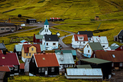 High angle view of road amidst houses in town