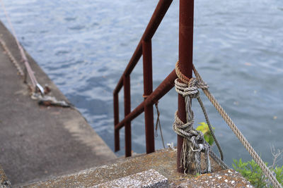 Close-up of rope tied to railing