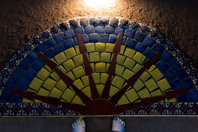 Low section of people standing on tiled floor