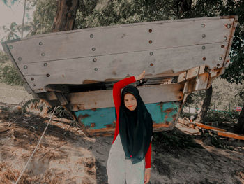 Full length portrait of woman standing on land