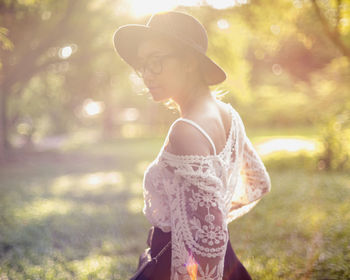 Side view of young woman looking away outdoors