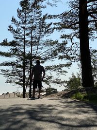 Rear view of man walking on road