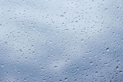 Full frame shot of raindrops on window