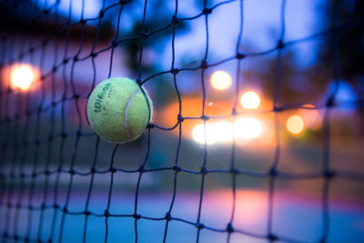 Close-up of yellow ball in net 