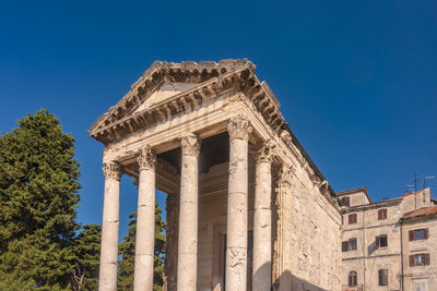 Low angle view of historical building against blue sky