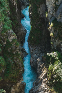 High angle view of waterfall amidst rocks