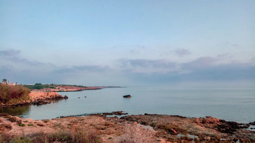 Scenic view of bay against sky