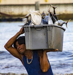 Portrait of shirtless man holding water