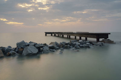 Pier over sea against sky