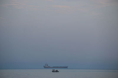 Boat sailing in sea against sky