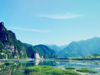 Scenic view of lake and mountains against sky