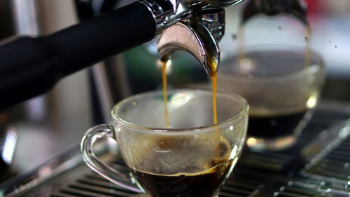 Close-up of coffee pouring in glass