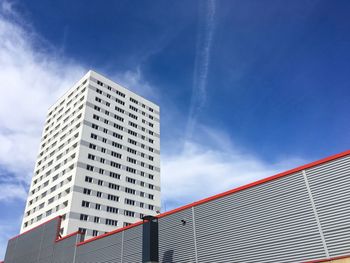 Low angle view of skyscraper against blue sky