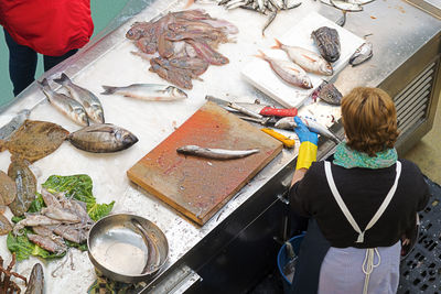 High angle view of woman holding fish in store