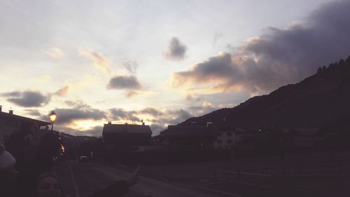 Silhouette cars on road against sky during sunset