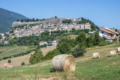 Panorama of the beautiful village of civitella del tronto with hay bales in the foreground