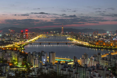 High angle view of illuminated buildings in city at night