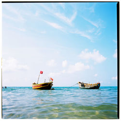 Boats in sea against sky