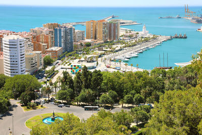 High angle view of buildings by sea against sky