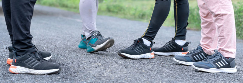 Low section of people standing on road