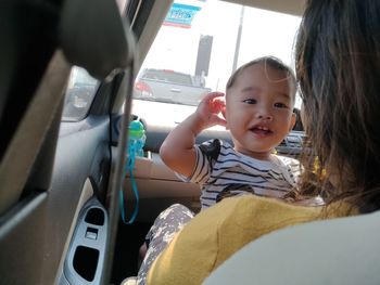 Portrait of cute smiling woman sitting in car