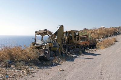 Wrecked and abandoned cars and ships in a remore location in the island
