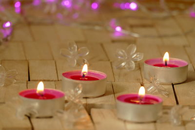 Close-up of illuminated candles in temple