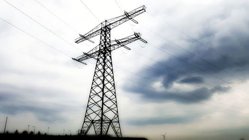 Low angle view of electricity pylon against sky